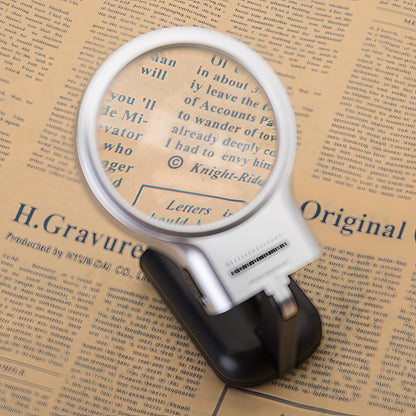 The Curious Mind foldable LED magnifier glass with a silver and black handle, ideal for hobbyists and detail work.