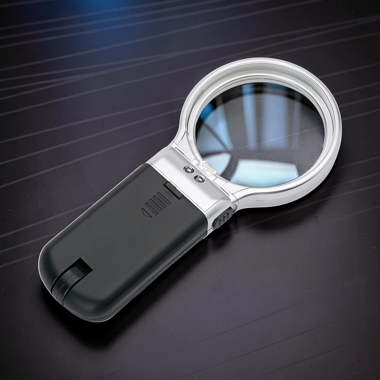 The Curious Mind foldable LED magnifier glass with silver trim and black handle, ideal for hobbyists and detail work.
