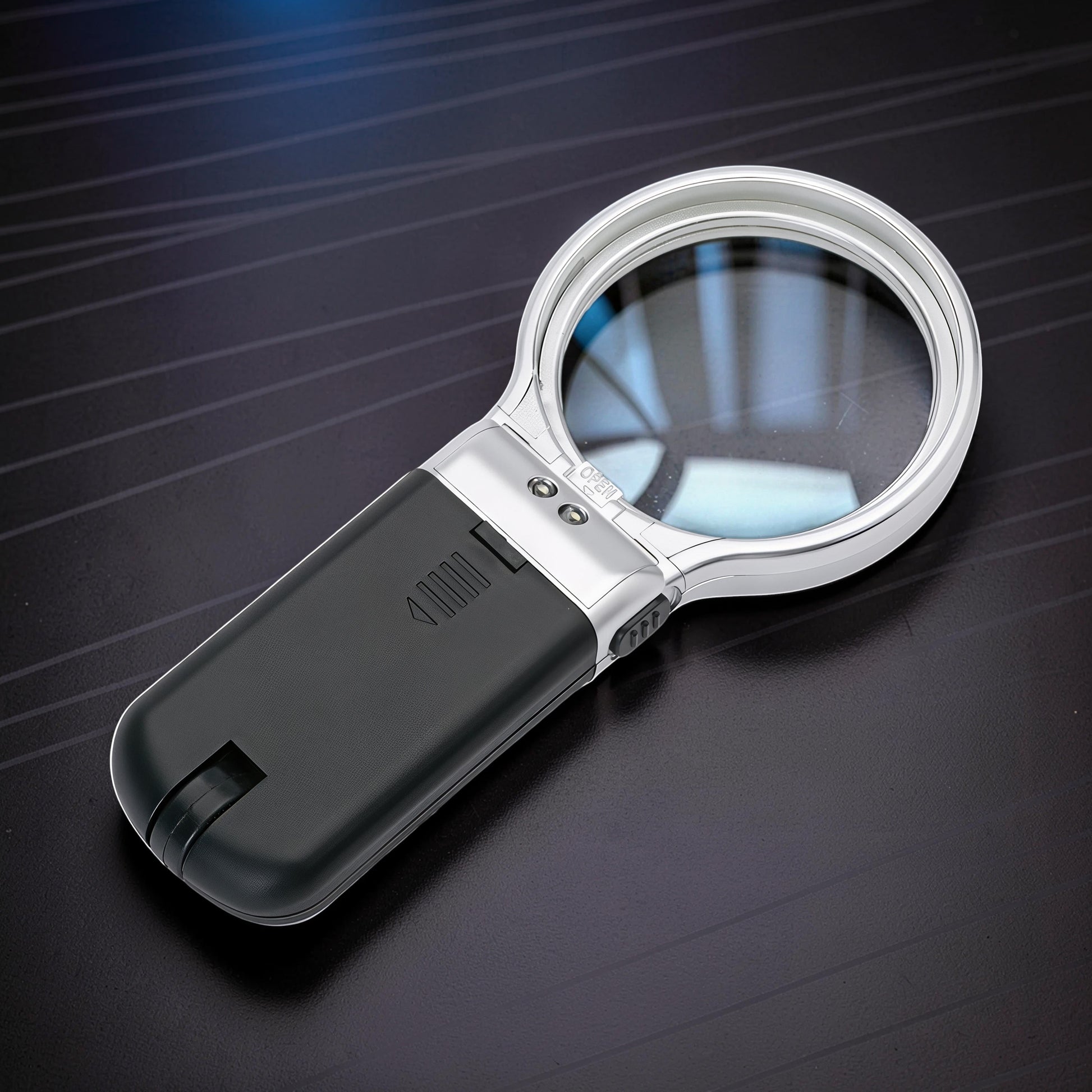 The Curious Mind foldable LED magnifier glass with silver trim and black handle, ideal for hobbyists and detail work.