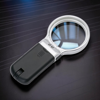 The Curious Mind foldable LED magnifier glass with silver trim and black handle, ideal for hobbyists and detail work.