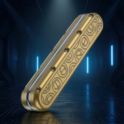 The Curious Mind Deep-Fried Dough Stick magnetic slider fidget toy in gold with a decorative pattern and tactile dots.
