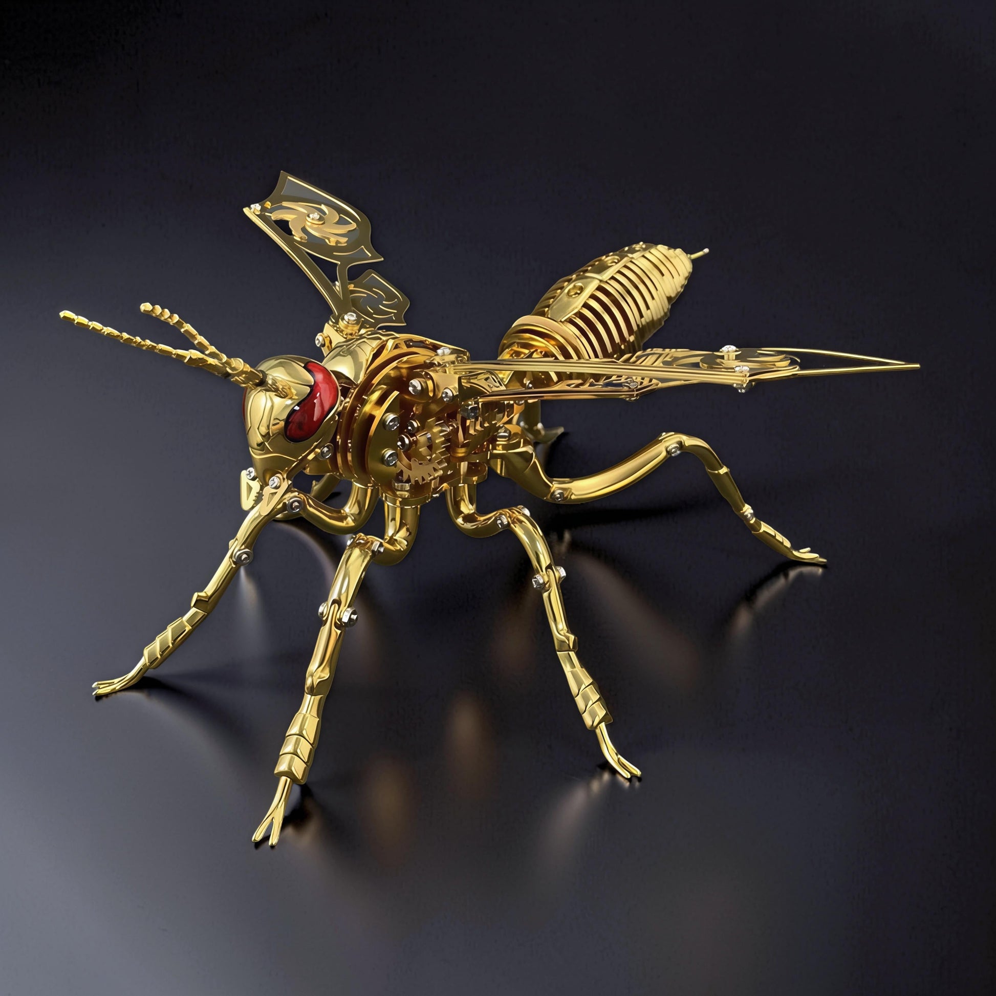 The Curious Mind Stainless Wasp 3D metal model kit, gold finish, intricate mechanical design with red eyes and detailed wings.