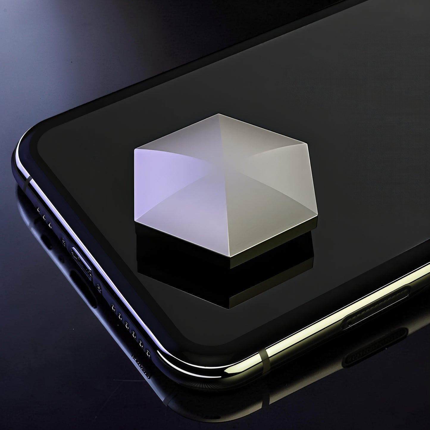 The Curious Mind Flipo Flip Hexagon kinetic desk spinner, a weighted metal geometric toy with a polished silver finish, shown on a smartphone.