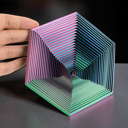 The Curious Mind Hexagon Push Fidget sensory toy with iridescent pink, blue, and green finish. Compact and tactile.