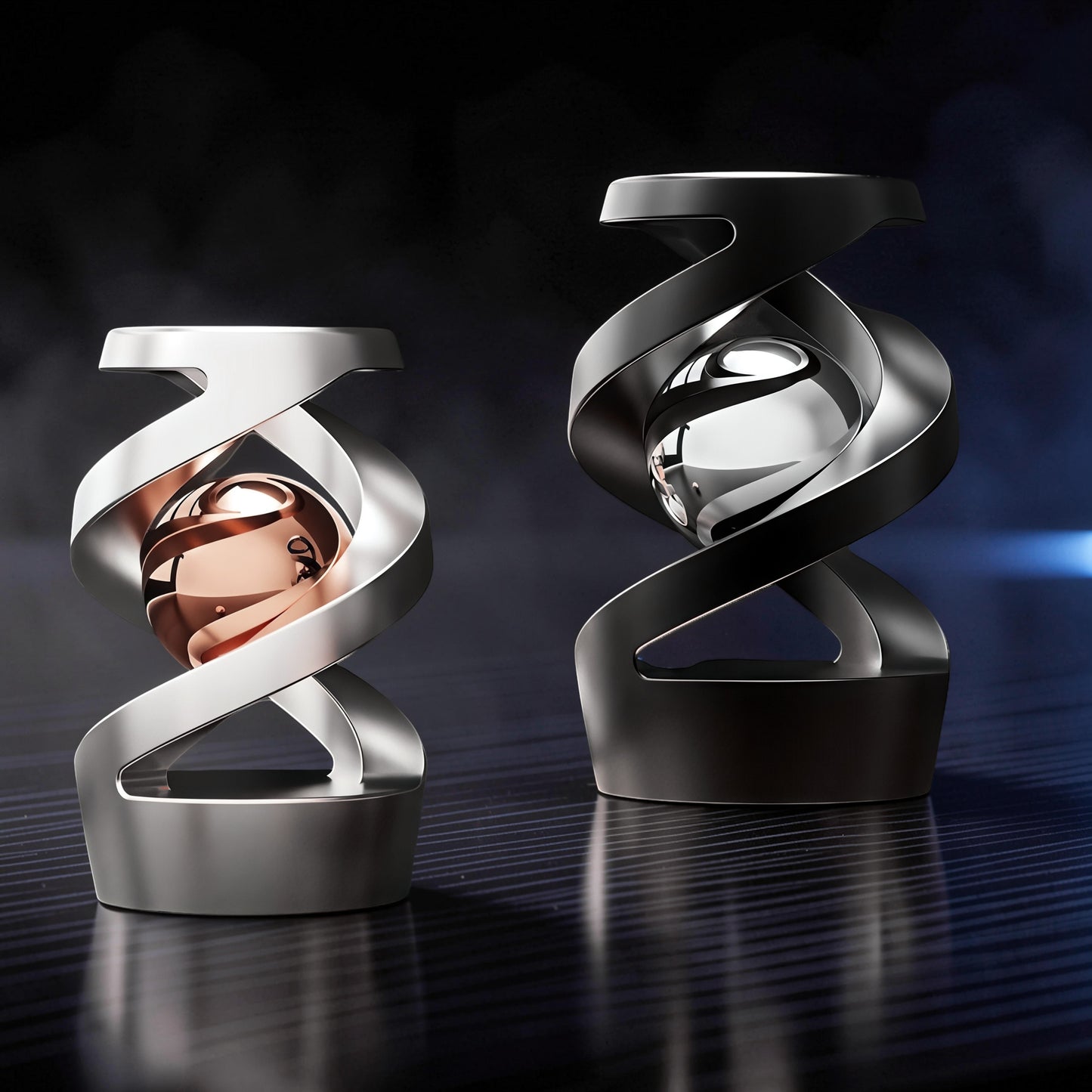 The Curious Mind Hypnosis Rotary Desk Spinner in silver with a rose gold sphere and black with a silver sphere. Metal construction.