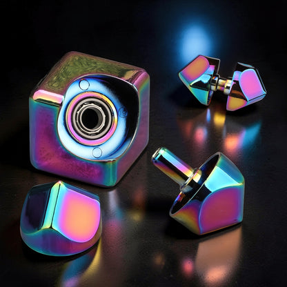 The Curious Mind iridescent metal spinner cube fidget toy with geometric design. Compact and pocket-sized.