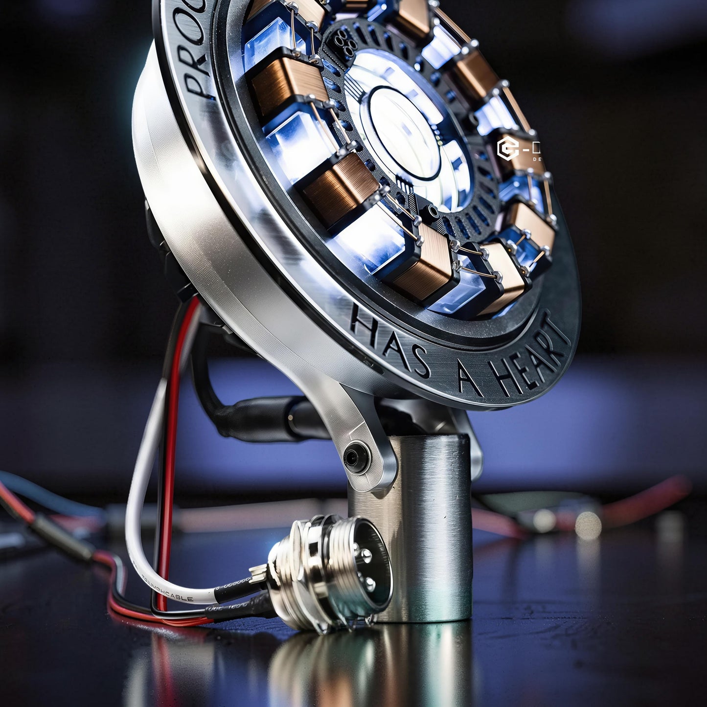 The Curious Mind Maglev Iron Man Ark Reactor Flagship HUD Edition, a metal desk object with blue lights and copper coils.