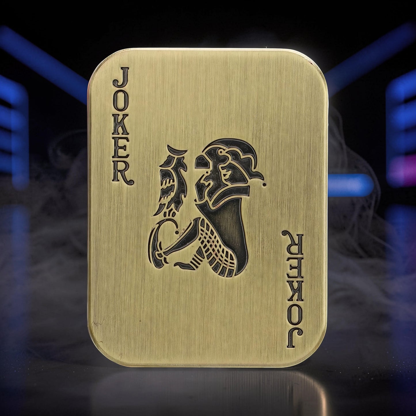The Curious Mind Joker Poker magnetic slider, a brass-toned metal fidget toy shaped like a playing card with a joker design.