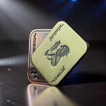 The Curious Mind Joker Poker magnetic slider fidget toy in brushed brass with Joker card design. Tactile metal slider for stress relief.