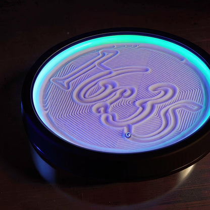 The Curious Mind Kinetic Mini Sand Painting Machine with illuminated sand patterns and a small metal ball.