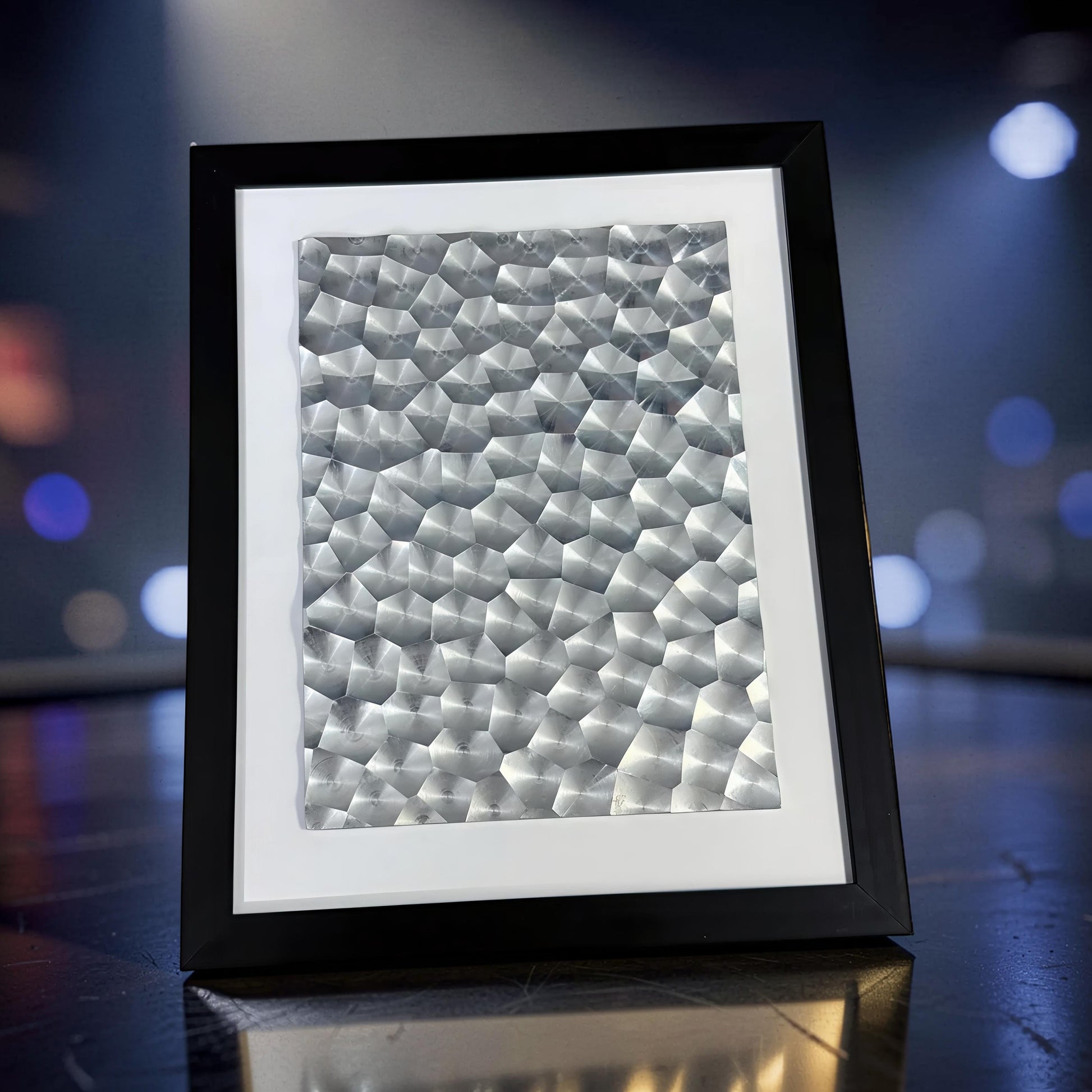 The Curious Mind black framed geometric laser light effect art display with textured metallic insert.