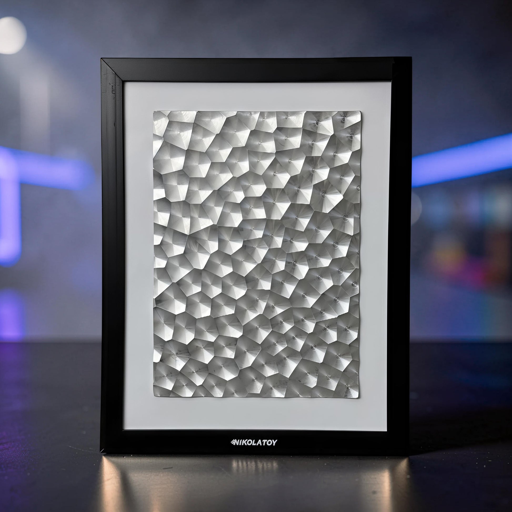 The Curious Mind Laser Light Effect Art Frame with a textured silver metal surface in a black wood frame.