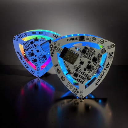 The Curious Mind Self-Balancing Lelo Triangle Kinetic Desk Toy with RGB LED lights and electronic components.
