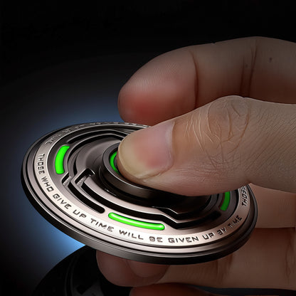 The Curious Mind Long Glow Bar Spinner, a premium metal fidget spinner with green glowing accents and engraved text.