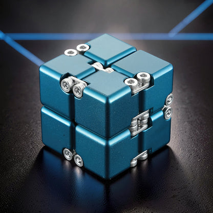 The Curious Mind Unlimited Magic Fidget Cube, a metallic blue, compact, magnetic desk toy with a satisfying cube shape and intricate metal detailing.