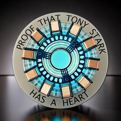 The Curious Mind Maglev Iron Man Ark Reactor Flagship HUD Edition, a metal desk object with a glowing blue center and copper accents.