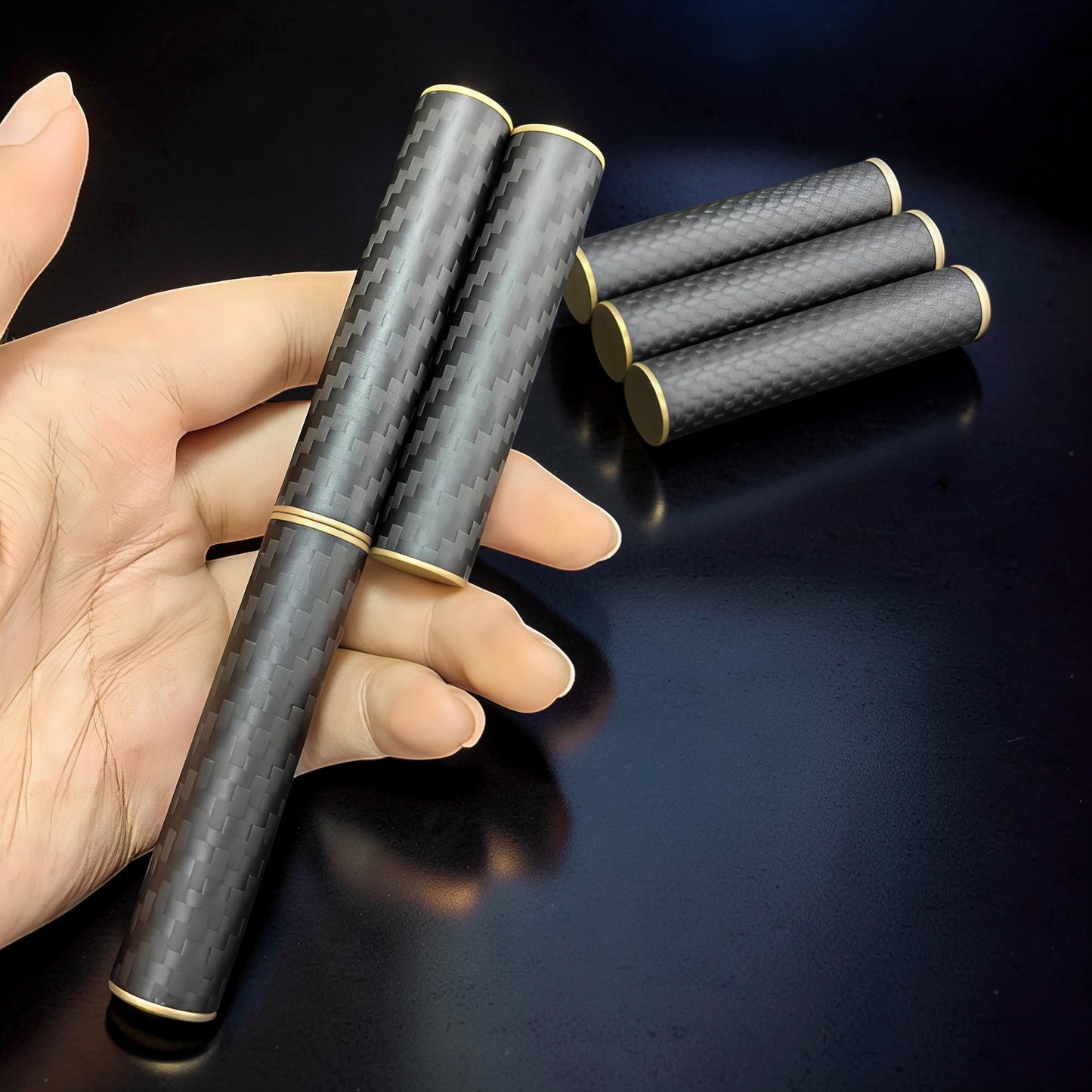 The Curious Mind Magnetic Carbon Fiber Slider fidget toy with gold accents, held in a hand.