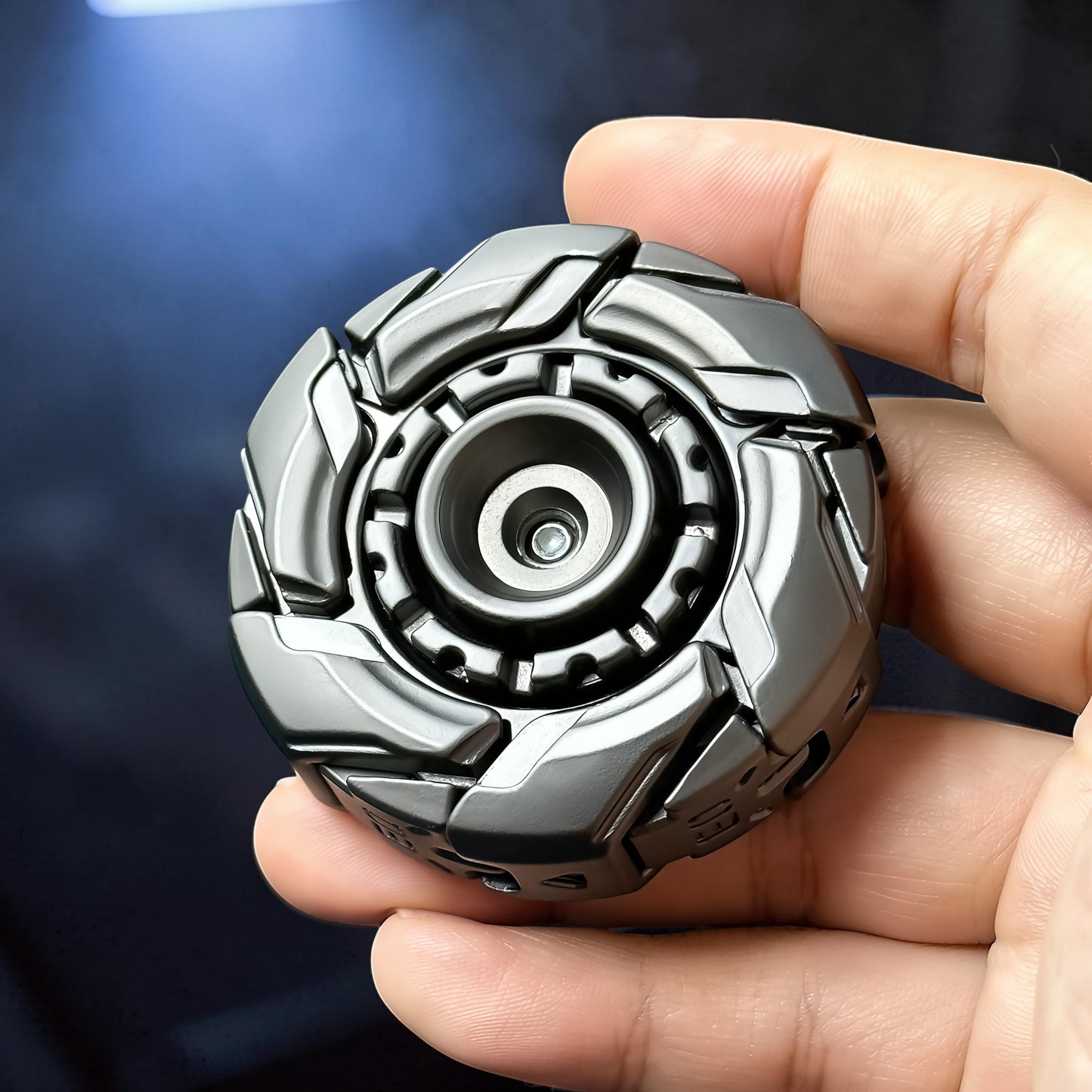 The Curious Mind Open Armour Magnetic Spinner is a metallic grey, armoured fidget spinner with a detailed, segmented design and magnetic accents.