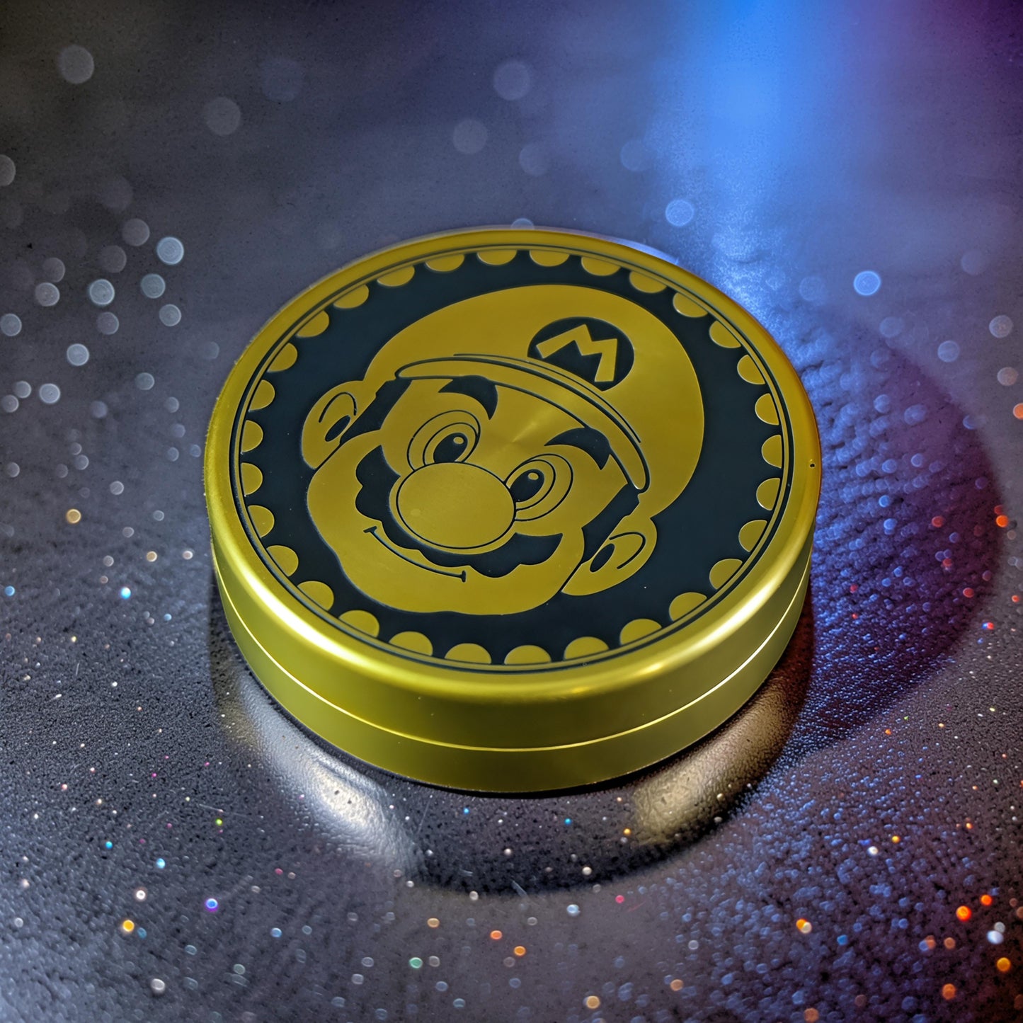 The Curious Mind Blacksmith Pop Coin Clicker, a gold metal fidget toy featuring Mario's face on a coin design.