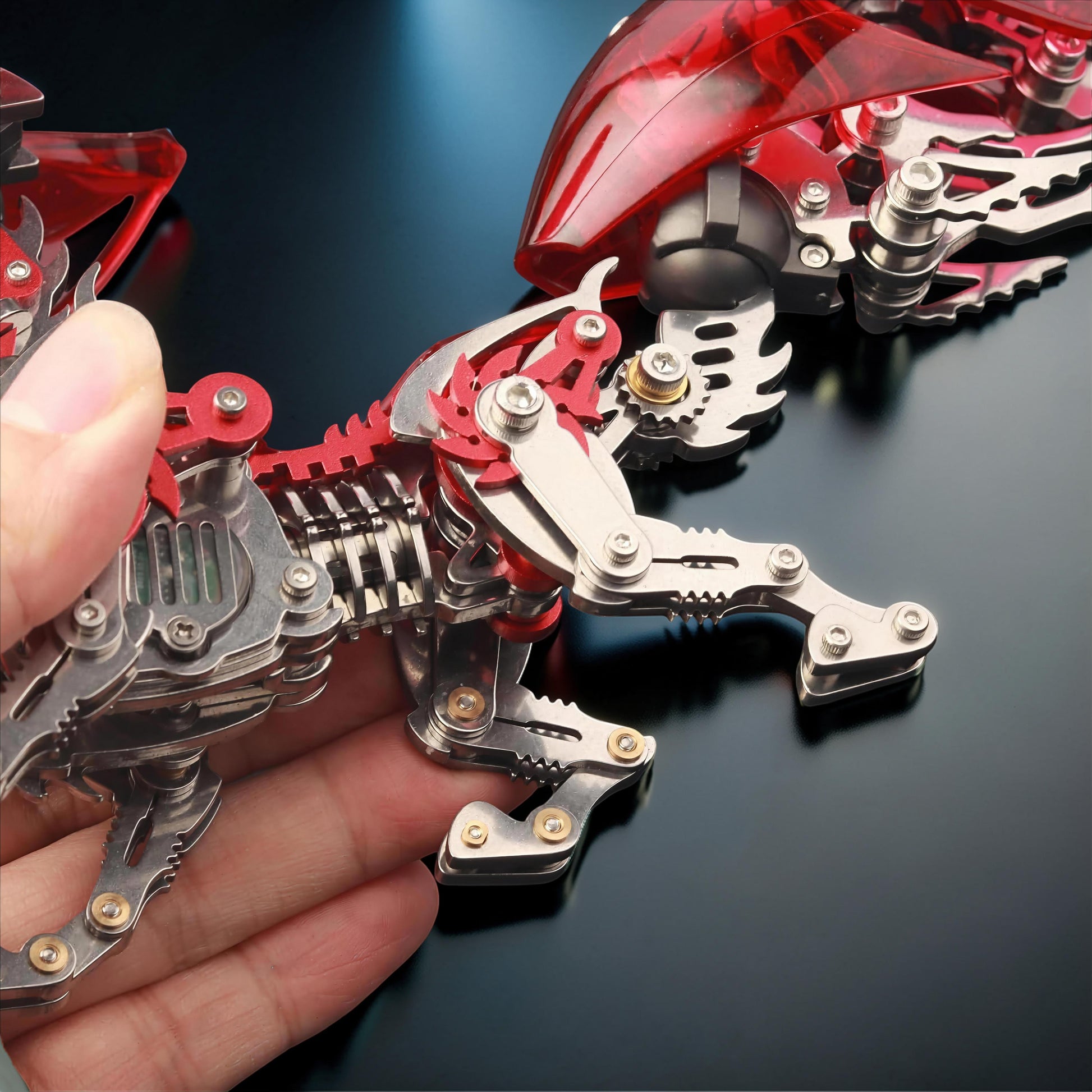 The Curious Mind Mechanical Fox 3D metal model kit with metallic silver frame and translucent red accents.