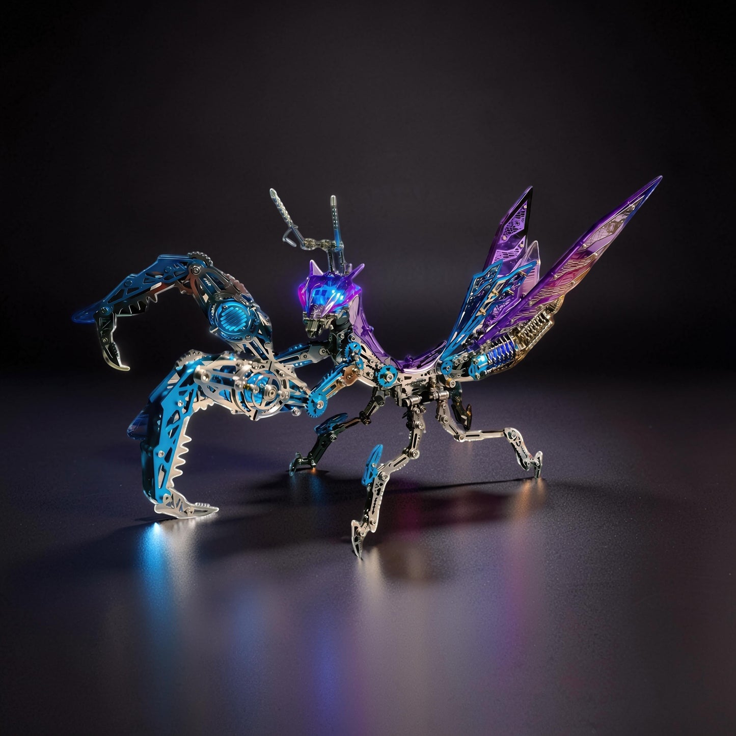 The Curious Mind Mechanical Mantis 3D metal model kit with blue and purple metallic finish, intricate details, and illuminated accents.