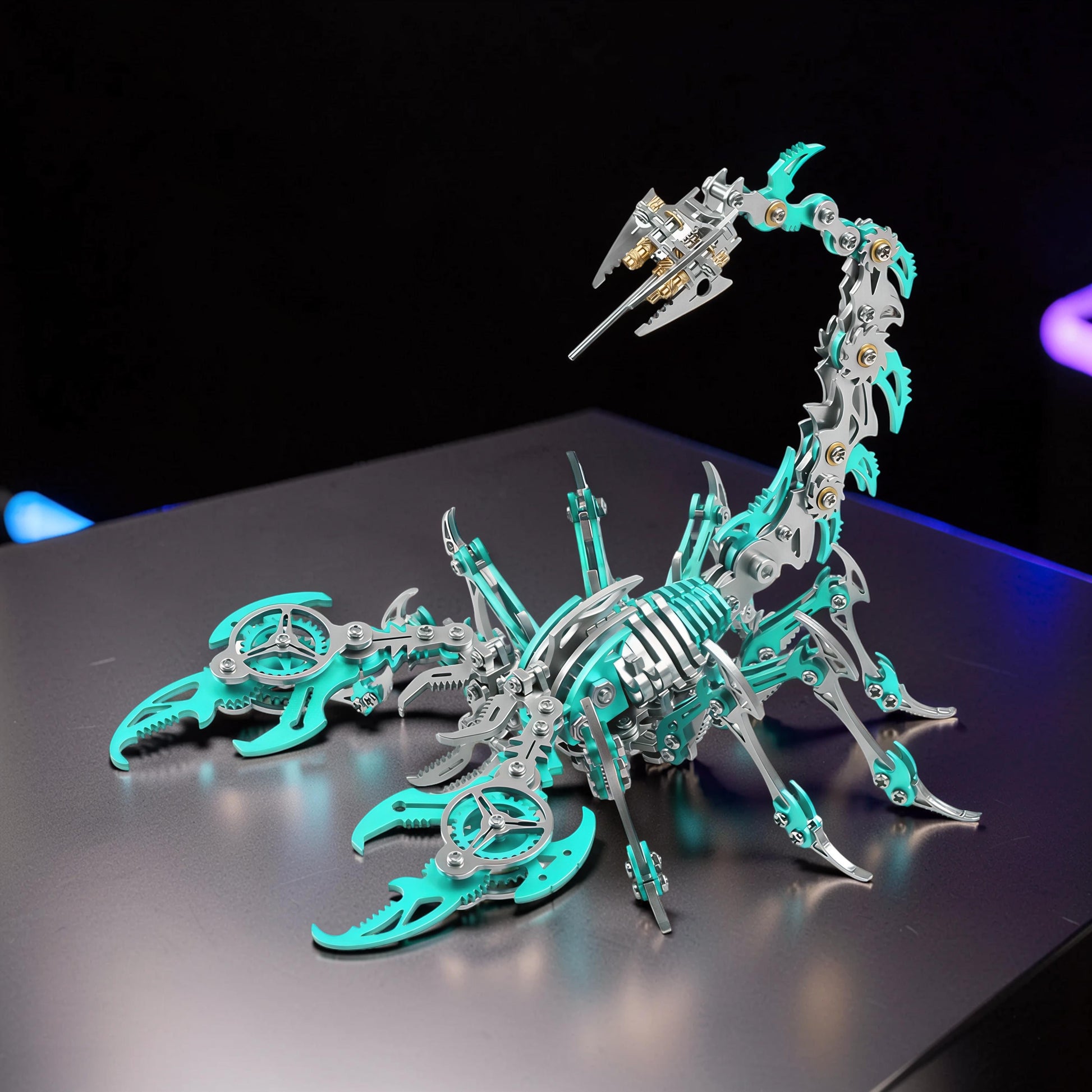 The Curious Mind Mechanical Scorpion 3D metal model kit in silver and teal with intricate gears and segmented tail.