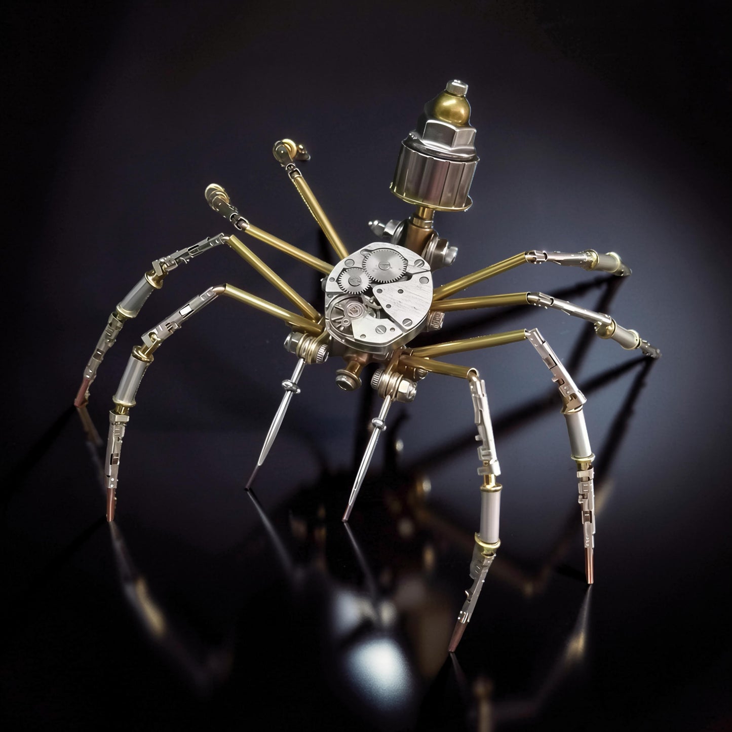 The Curious Mind Style A mechanical spider DIY kit, made of metal with intricate gears and brass legs.