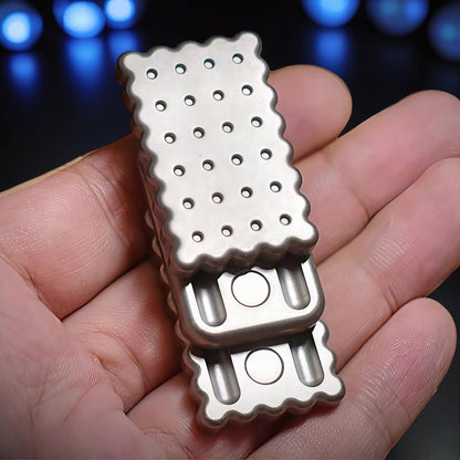 The Curious Mind Biscuit Push Card Slider, a compact metal fidget toy with a silver finish, designed for tactile feedback and stress relief.