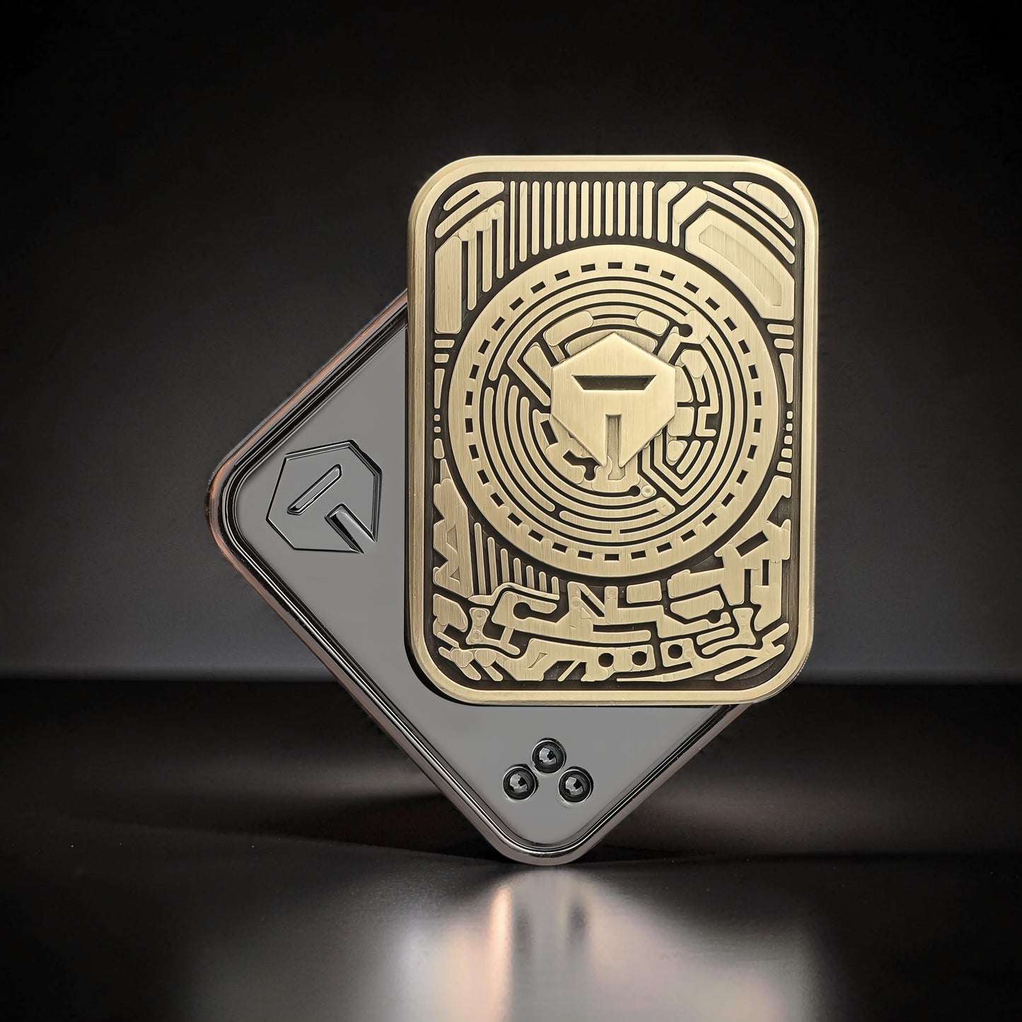 The Curious Mind Three-Body Push Card Fidget, a compact metal fidget toy with intricate gold and silver geometric designs, ideal for focus and stress relief.