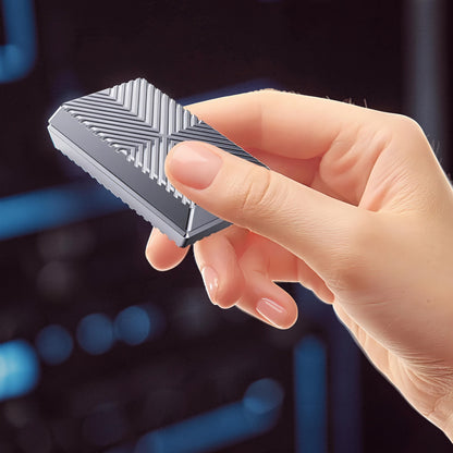 The Curious Mind Cube Push Slider, a compact metal fidget toy with a textured geometric pattern, held in a hand.