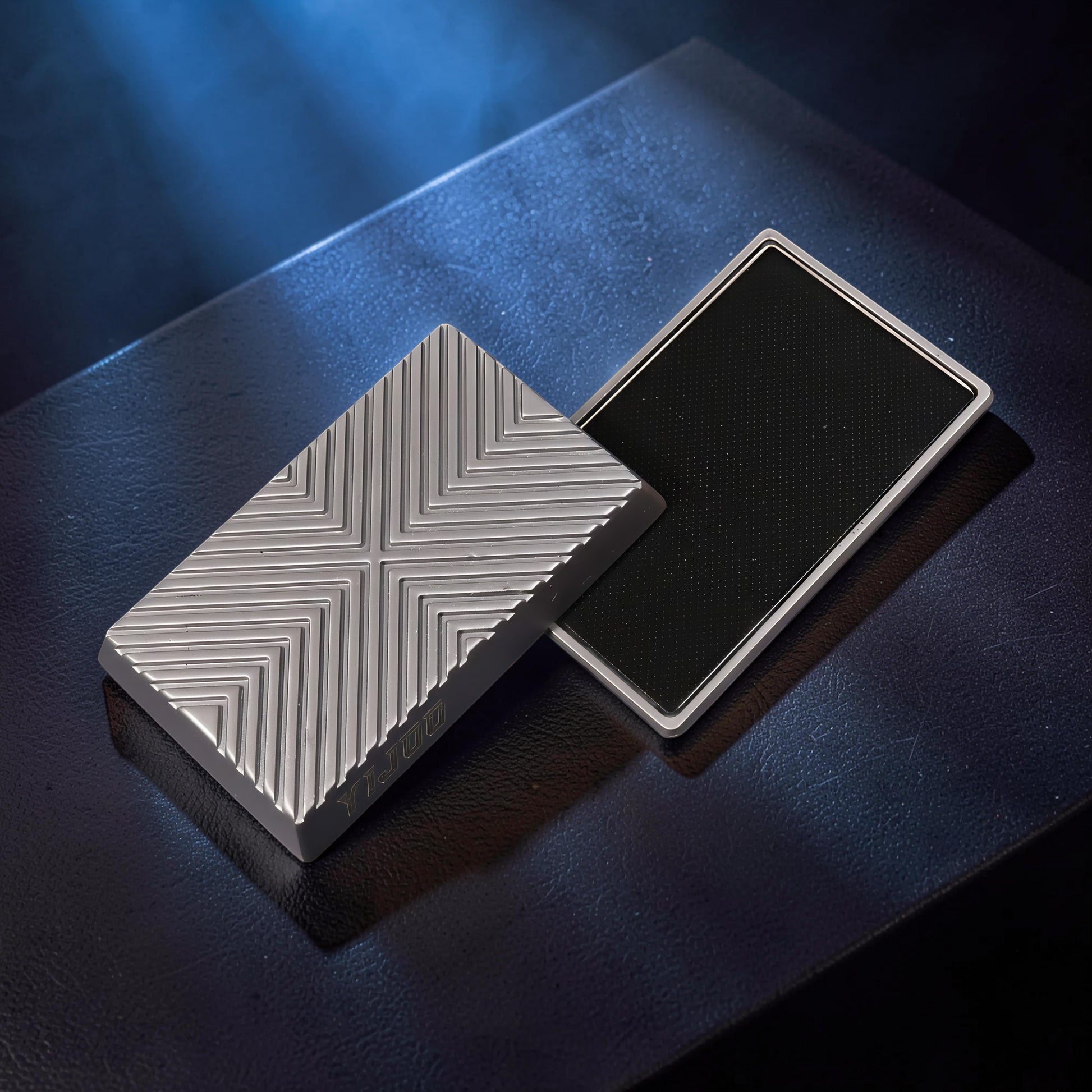 The Curious Mind Cube Push Slider fidget toy, silver metal with geometric grooved pattern and black textured grip.