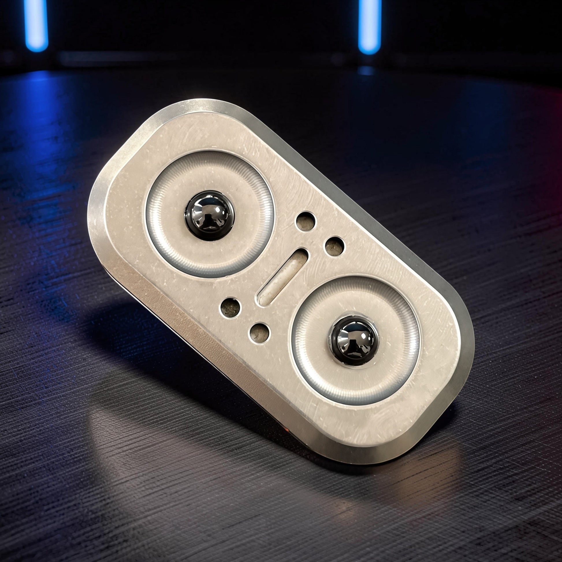 The Curious Mind Owl Push Slider: compact metal fidget toy with two magnetic sliders and a tactile push-and-return motion.