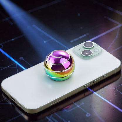 The Curious Mind high-gloss metal desktop stress ball with iridescent rainbow finish, designed for fidgeting and stress relief.