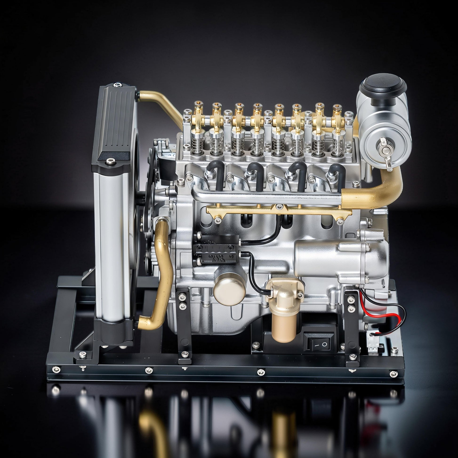 The Curious Mind Mini Diesel 4-Cylinder Engine DIY Kit, a detailed metal mechanical model with silver and gold accents, featuring a radiator and display stand.
