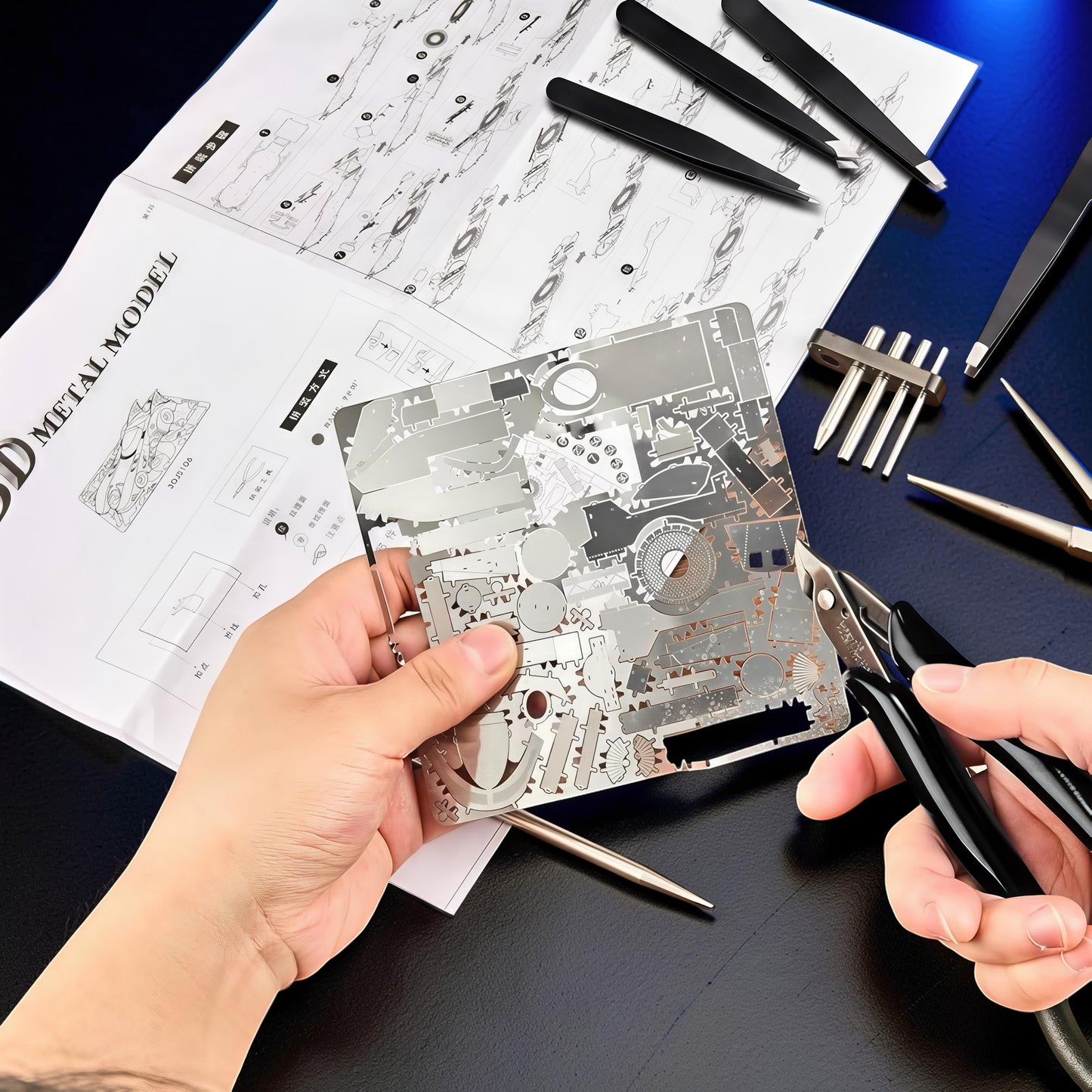 The Curious Mind Precision Model Builder Toolkit with metal model sheet, tweezers, cutters, and instructions.