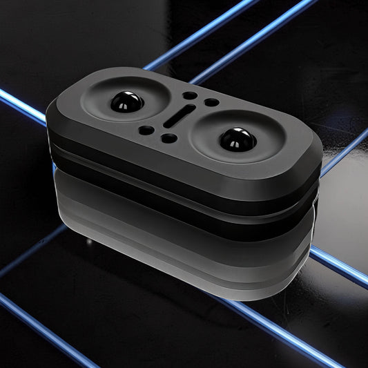 The Curious Mind Owl Push Slider, a compact black metal fidget toy with two spherical bumps and a central slot.