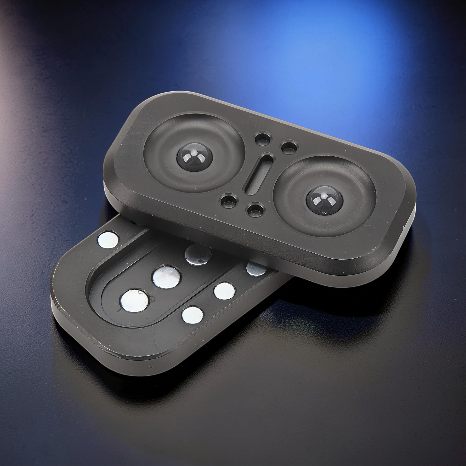 The Curious Mind Owl Push Slider, a compact black metal fidget toy with a satisfying push-and-return motion.