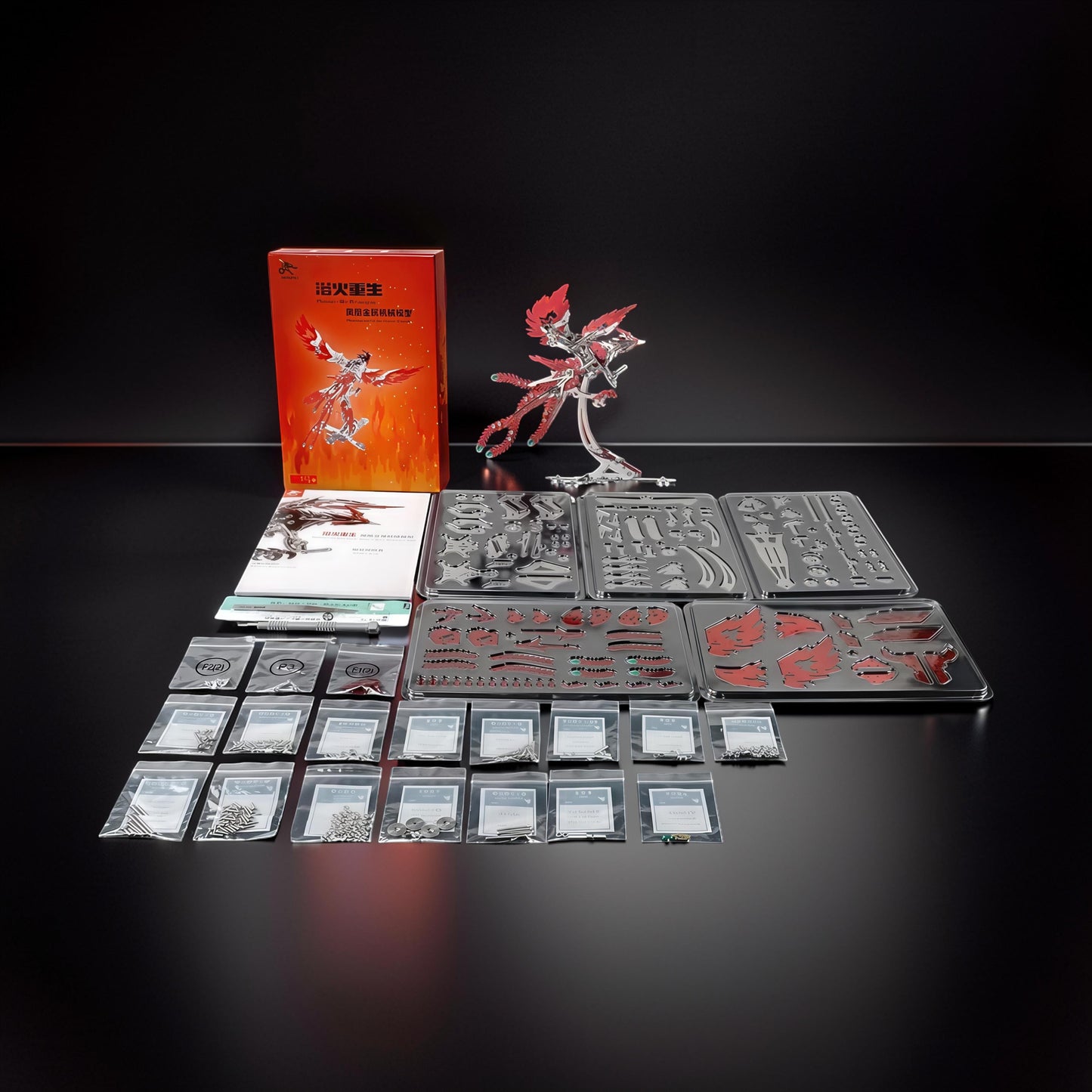 The Curious Mind Phoenix DIY Kit features silver and gold metal parts for a mechanical creature model. Includes instructions and all components for assembly.
