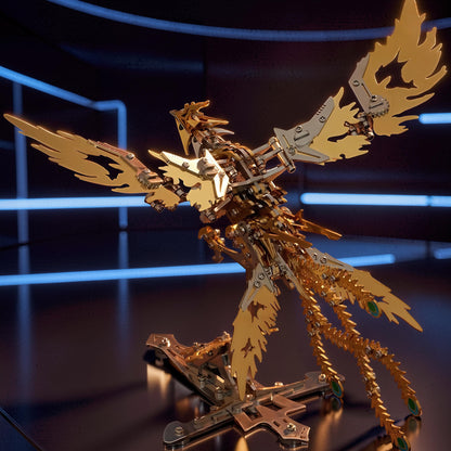 The Curious Mind Phoenix DIY Kit, a mechanical metal model in silver and gold with intricate feather details and a display stand.