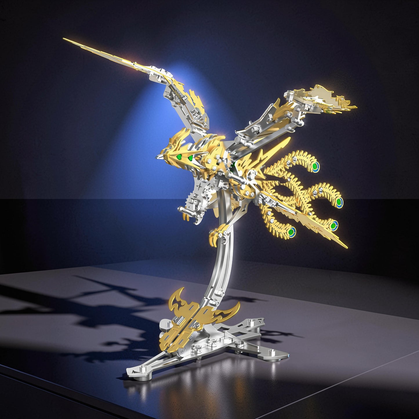 The Curious Mind Phoenix DIY Kit, a silver and gold mechanical bird model with green gem eyes, displayed on a stand.