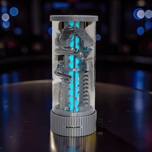 The Curious Mind Spinning Pinball RGB Night Light features a grey PLA construction with a bright blue LED core, set in a clear cylinder on a ribbed base.