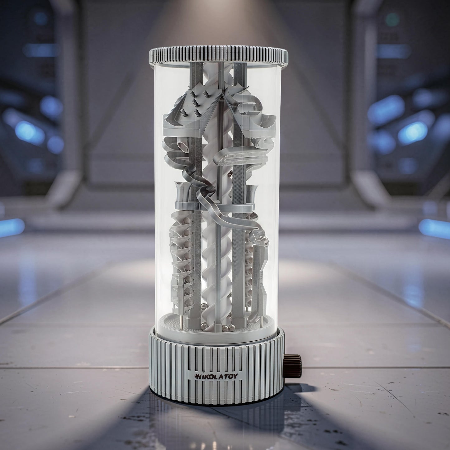 The Curious Mind Spinning Pinball RGB Night Light features a clear cylinder showcasing a complex marble run with PLA components and silver balls. The base has a ribbed design and a dark knob.