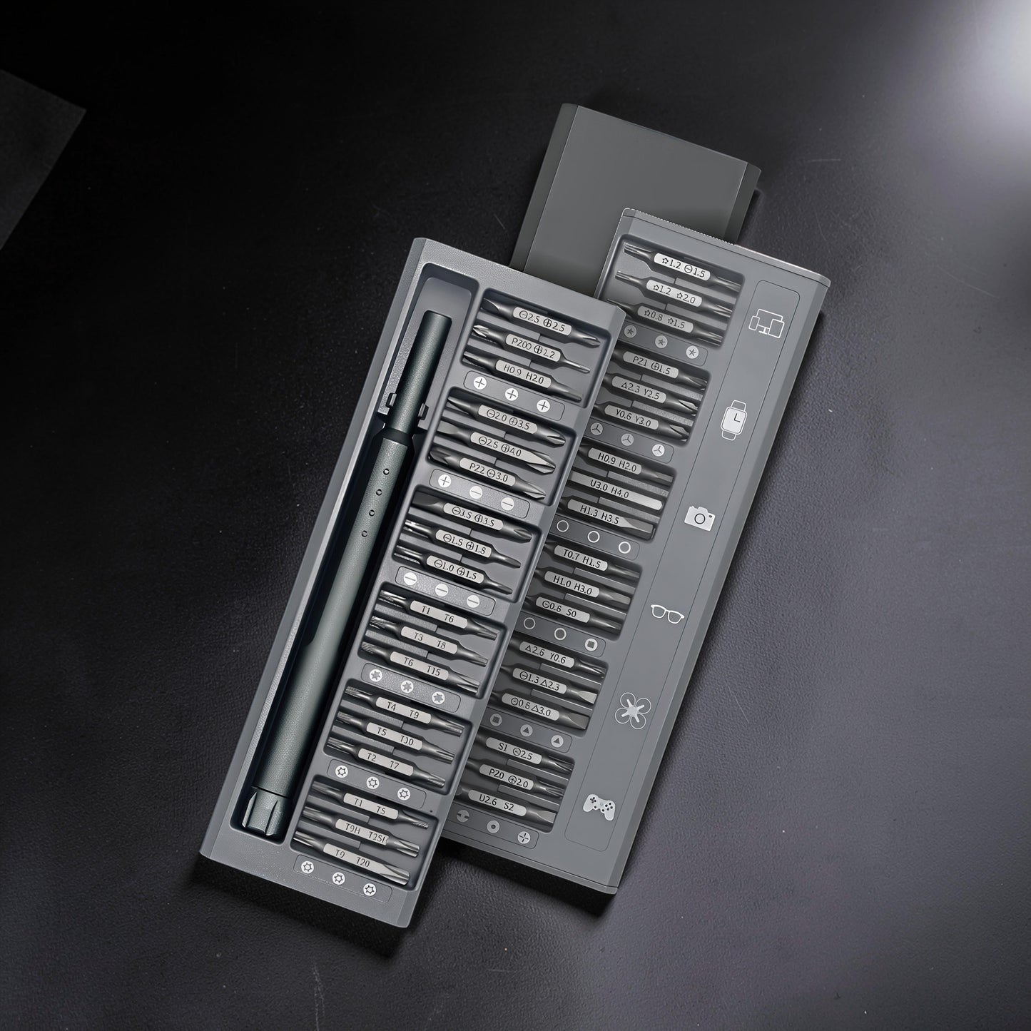 The Curious Mind 36-in-1 magnetic precision screwdriver set in grey, featuring various bits for electronics and small repairs.