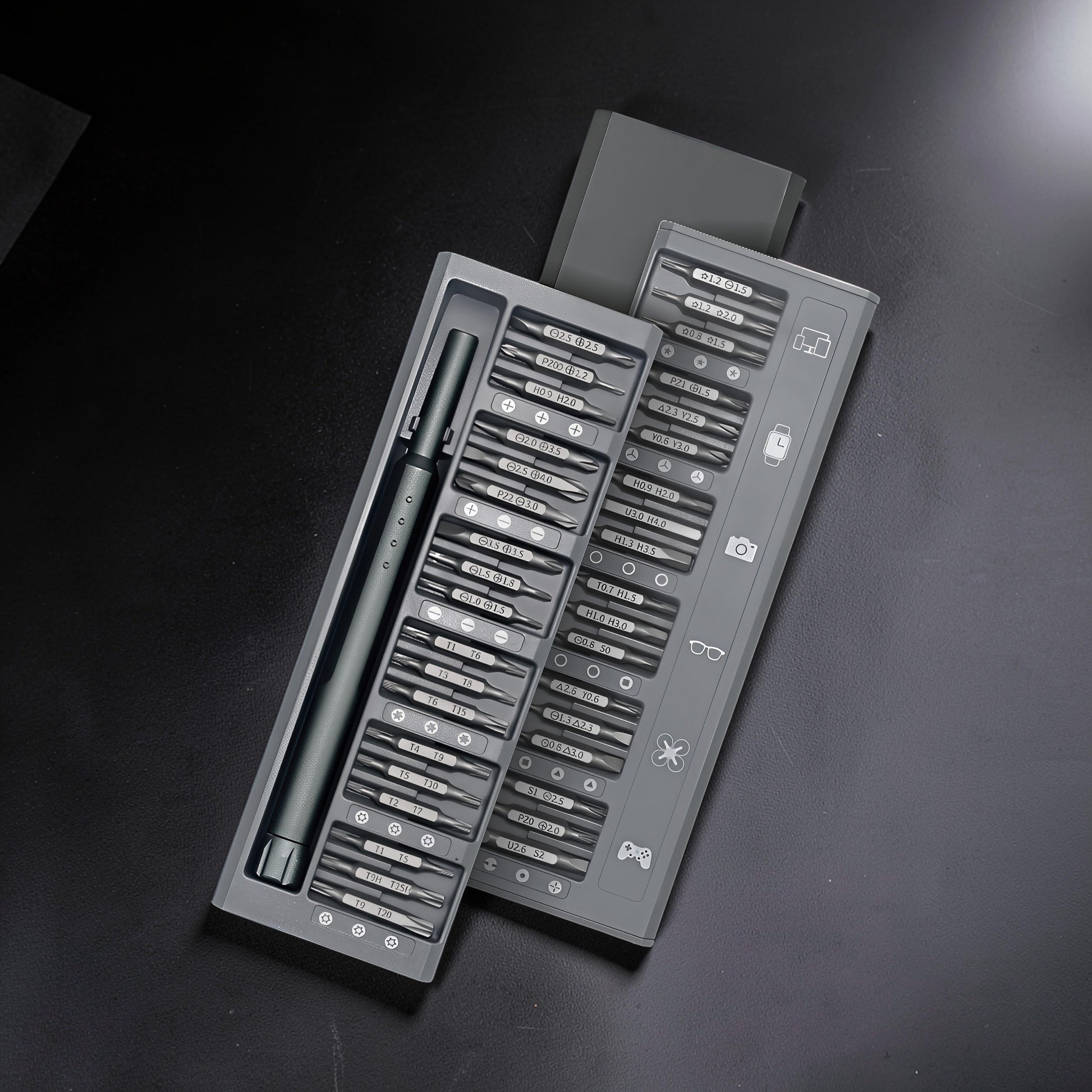 The Curious Mind 36-in-1 magnetic precision screwdriver set in grey, featuring various bits for electronics and small repairs.