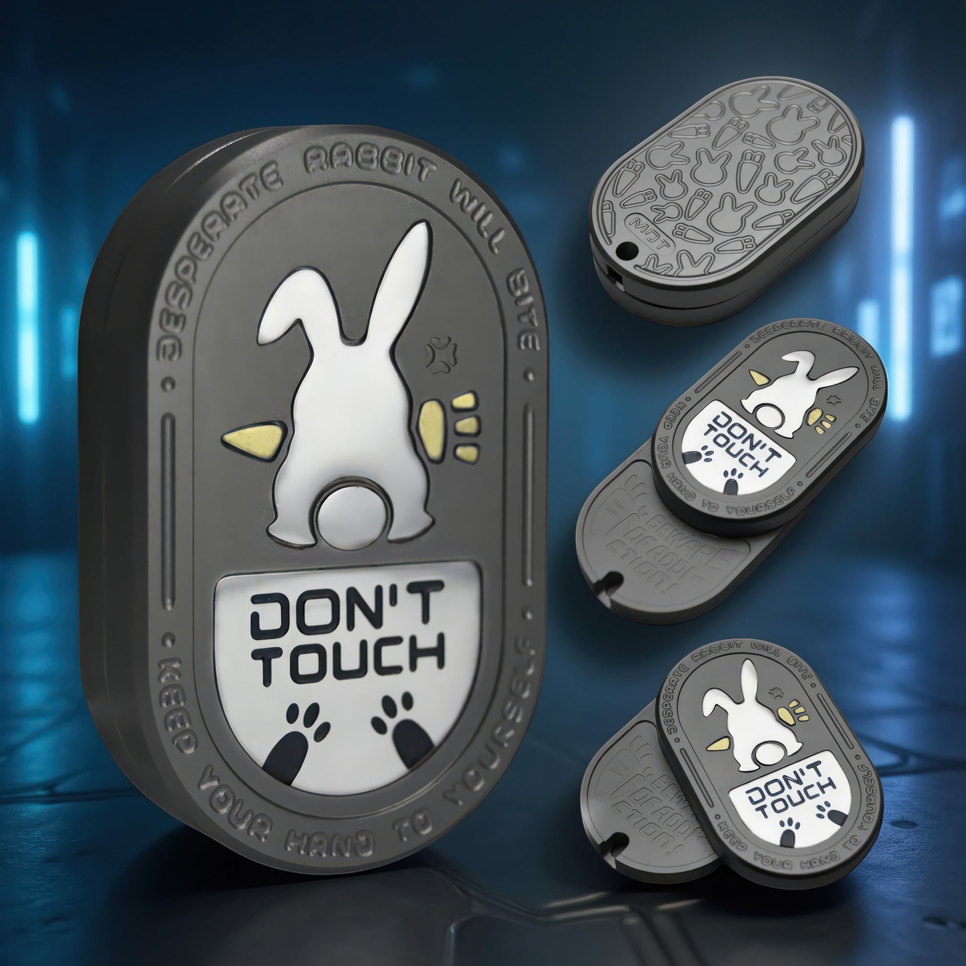The Curious Mind Don't Touch Rabbit Slider fidget toy, a grey metal badge with a white rabbit and warning text.