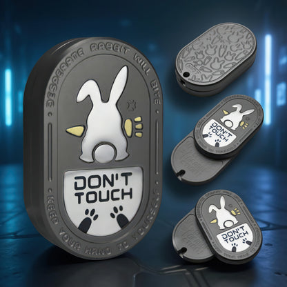 The Curious Mind Don't Touch Rabbit Slider fidget toy, a grey metal badge with a white rabbit and warning text.