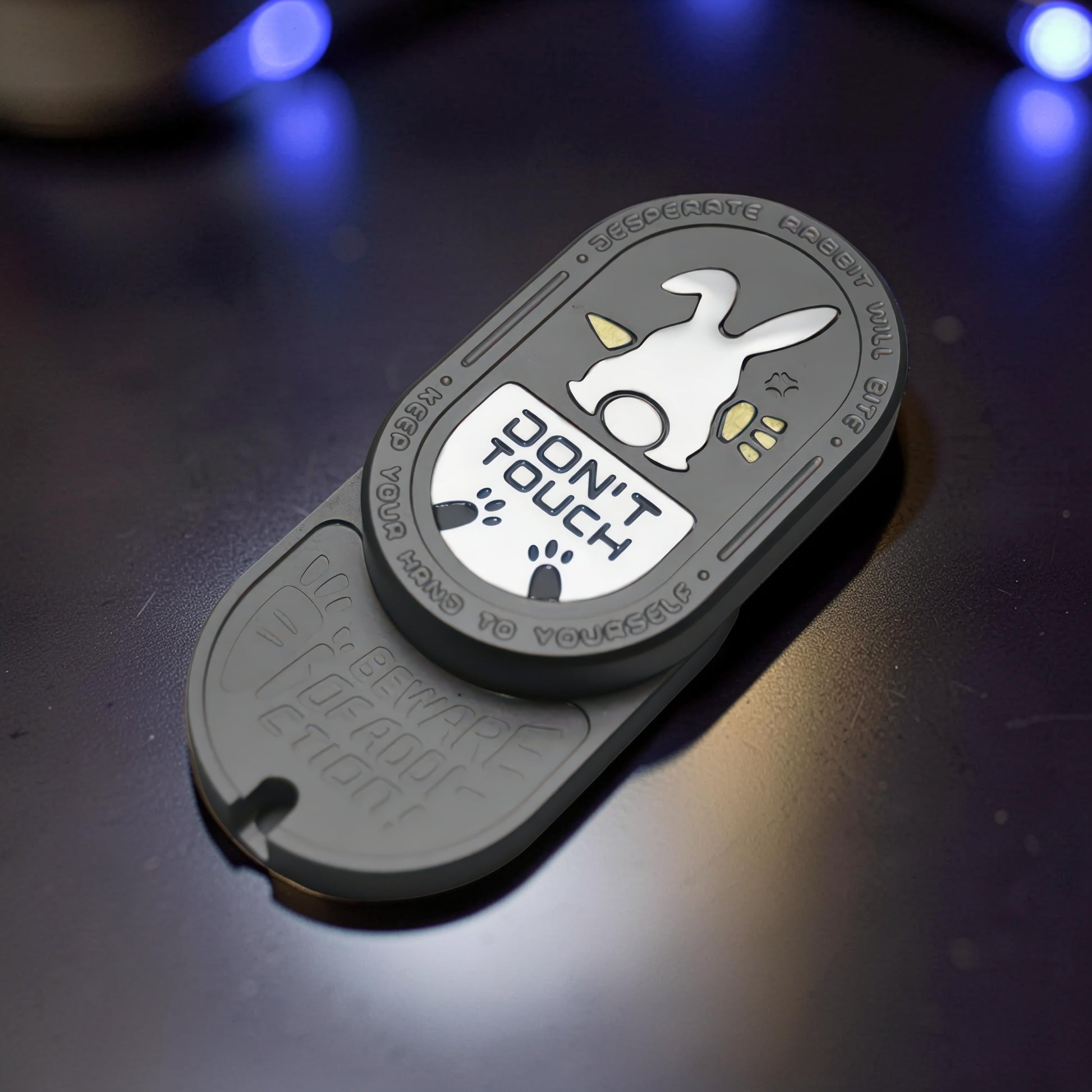 The Curious Mind Don't Touch Rabbit Slider fidget toy with a grey metal body and playful rabbit design.