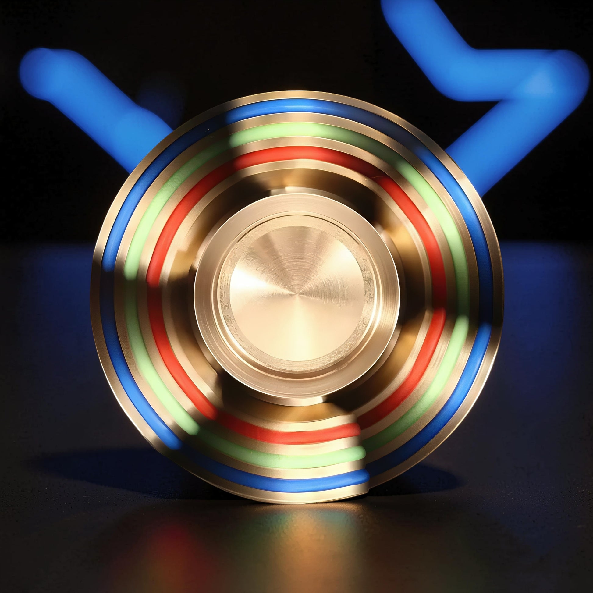 The Curious Mind Rainbow Metal Hand Spinner with blue, green, and red accents. Premium EDC fidget toy.