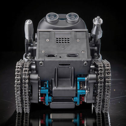 The Curious Mind RC Tank Robot DIY Kit features a metallic grey body with dual tracks, blue and red mechanical accents, and a distinctive head with two large lenses.