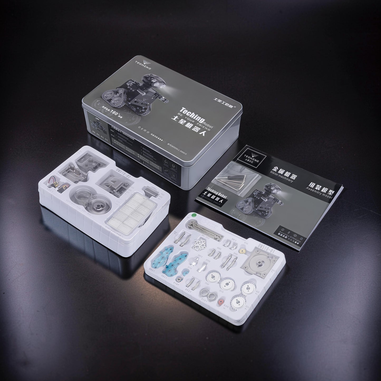 The Curious Mind RC Tank Robot DIY Kit with metal parts, instructions, and tin packaging. Features Bluetooth Mecha build.